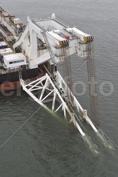The cargo ship with the crane, the top view. Pipelaying barge