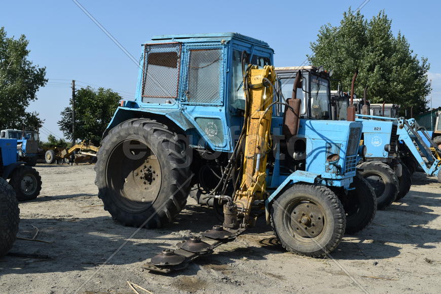 Tractor, standing in a row. Agricultural machinery. Parking of agricultural machinery.