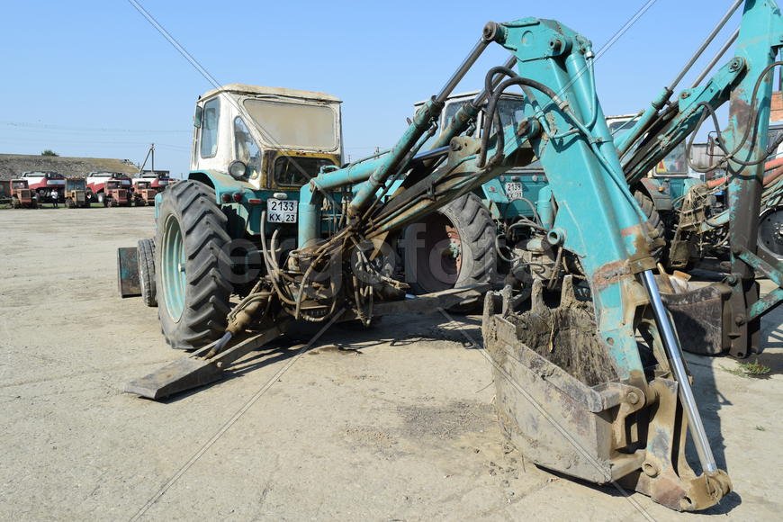Tractor, standing in a row. Agricultural machinery. Parking of agricultural machinery.