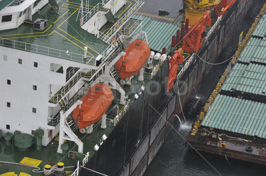The cargo ship with the crane, the top view. Pipelaying barge