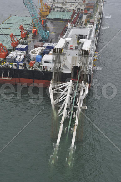 The cargo ship with the crane, the top view. Pipelaying barge
