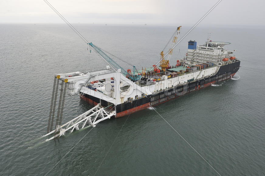 The cargo ship with the crane, the top view. Pipelaying barge