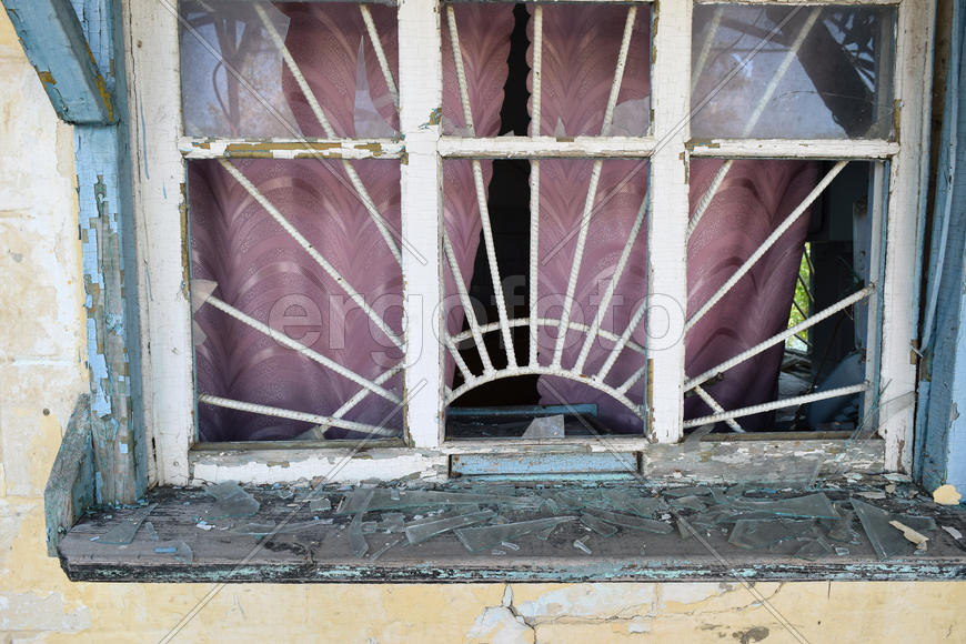 Windows with the broken glasses. The old thrown gas station