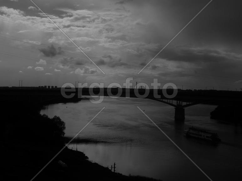 Bending river with banks on a black and white photo