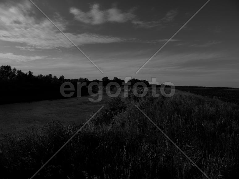Bending river with banks on a black and white photo