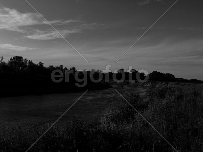 Bending river with banks on a black and white photo