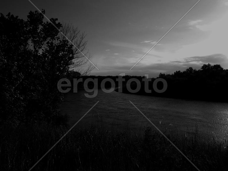 Bending river with banks on a black and white photo