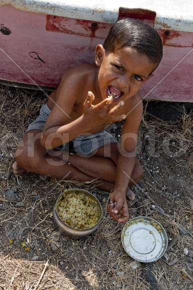 Boy eats porridge on Elephant Island