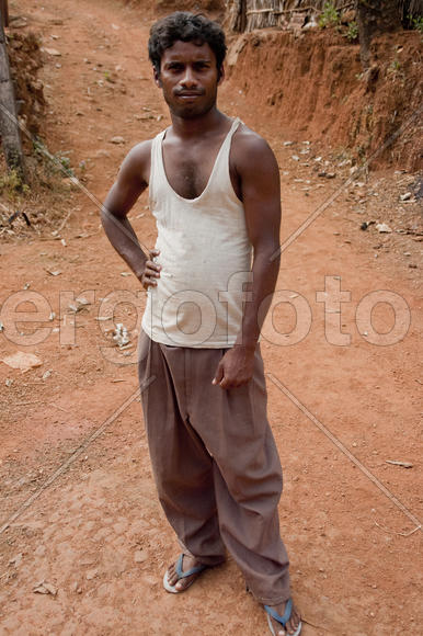Guy in a white T-shirt standing on the ground in the middle of the village street