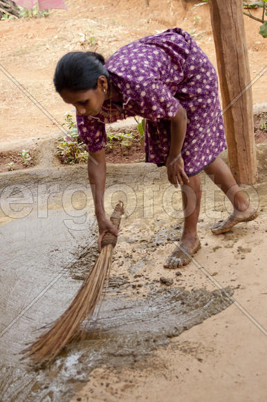 Young woman lubricates the liquid clay terrace