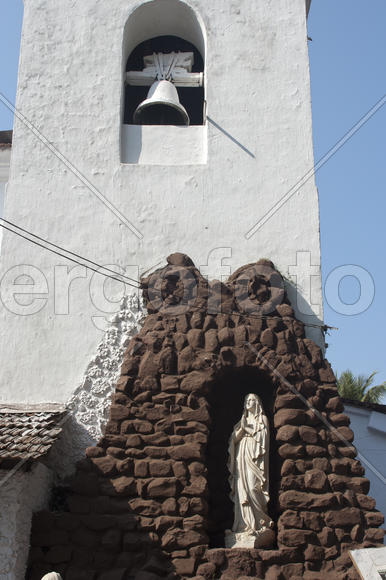 Bell tower and the statue of the Virgin Mary in South Goa