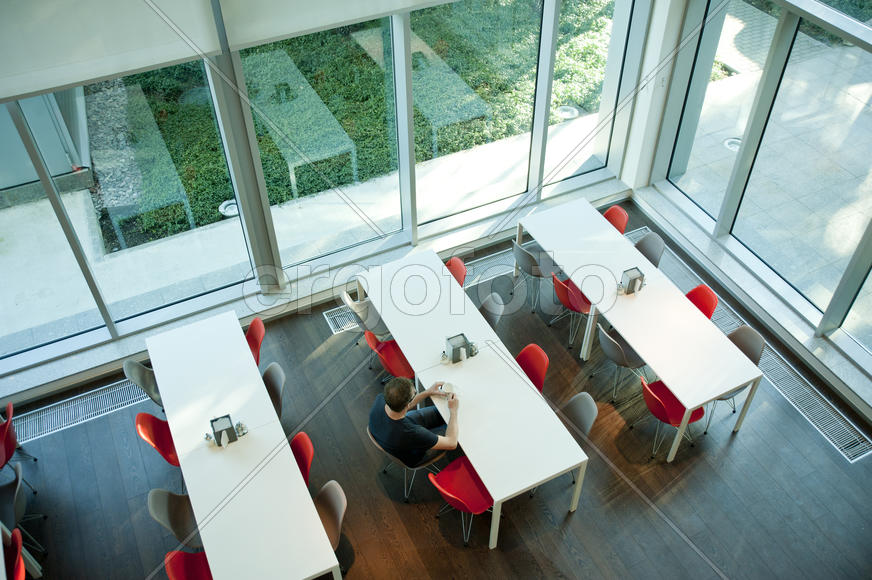 Empty office room with tall windows