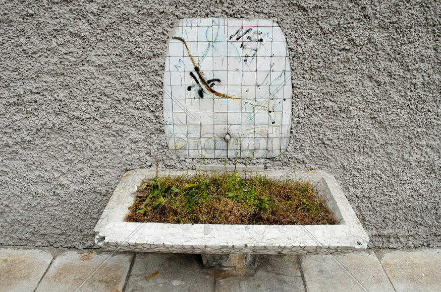 Old broken water dispenser in summer city cafeteria