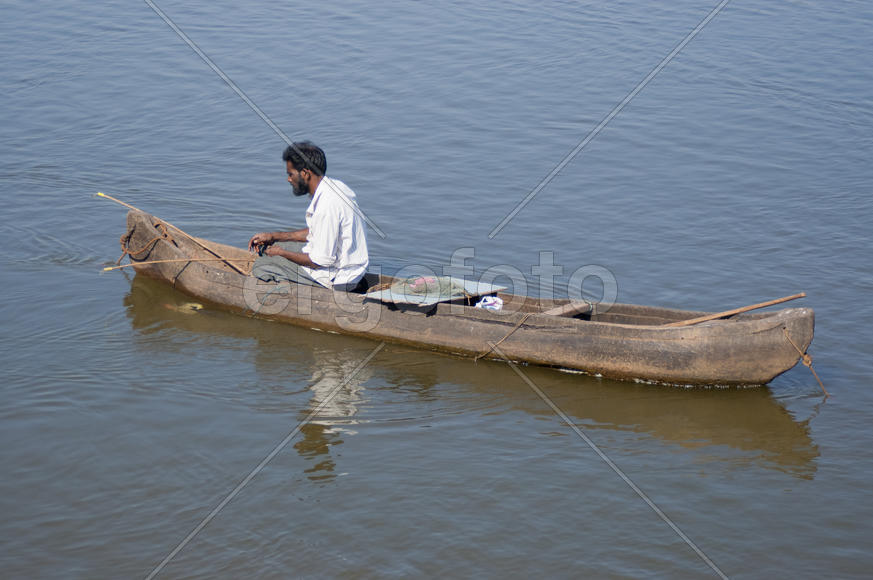 Fisherman fishes on the lake in the old Goa