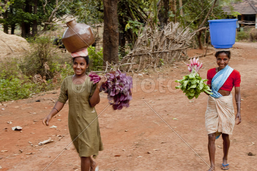 Woman carries water in a jar home