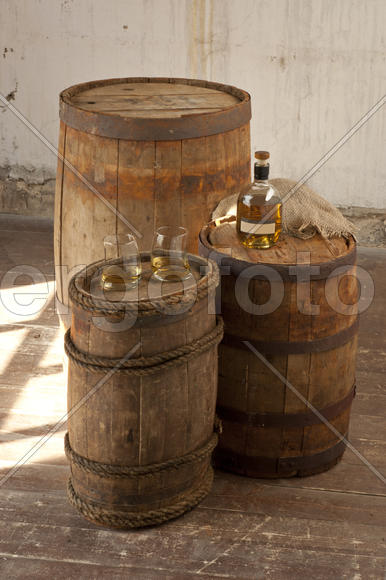 Oak barrels and bottled whiskey