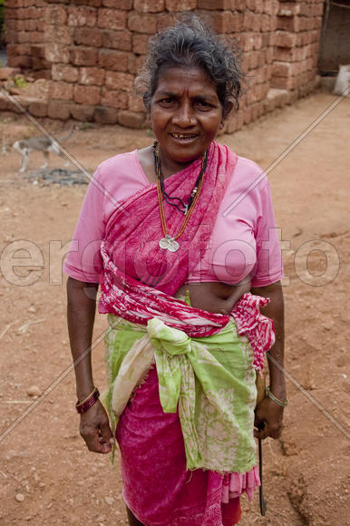 An elderly woman in a pink dress