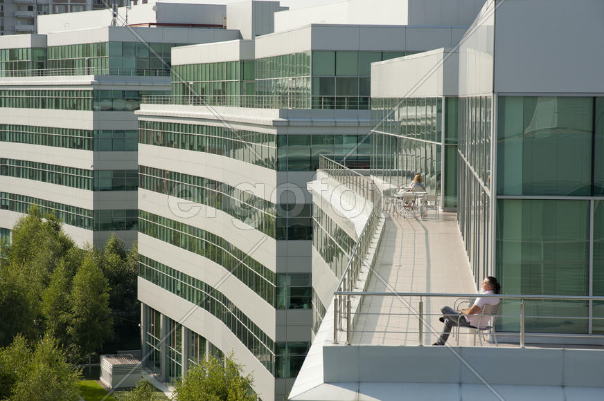Man resting on outdoor terrace.