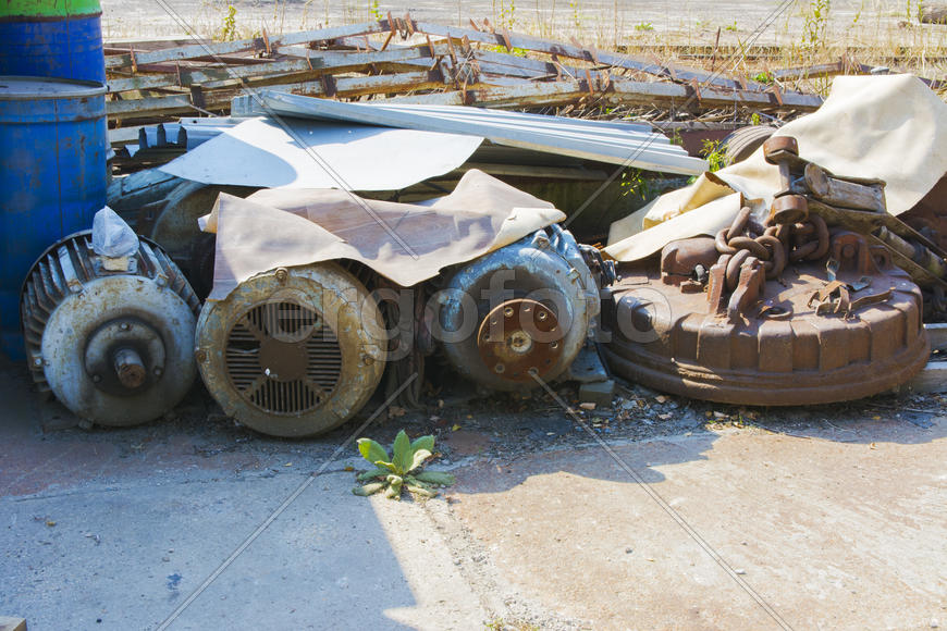 Old rusty engine in an abandoned factory in the industrial zone
