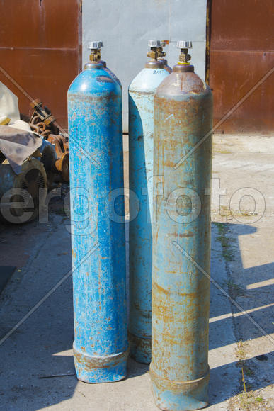 Old rusty oxygen cylinders in an abandoned factory in the industrial zone