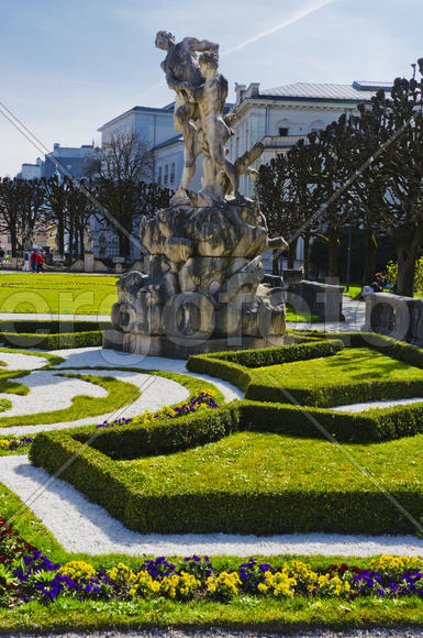 The lawn in the park. The beds of ornamental flowers