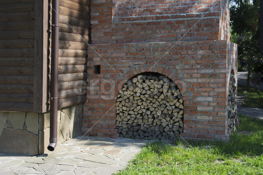 Firewood stacked near the stove near a private house