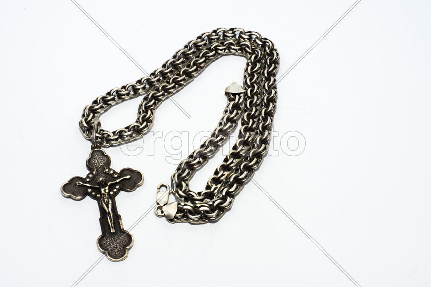 Браслеты, цепочки и кресты из серебра на белом фоне