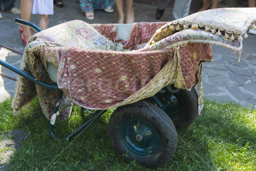 Wheelbarrow on the lawn near a private house