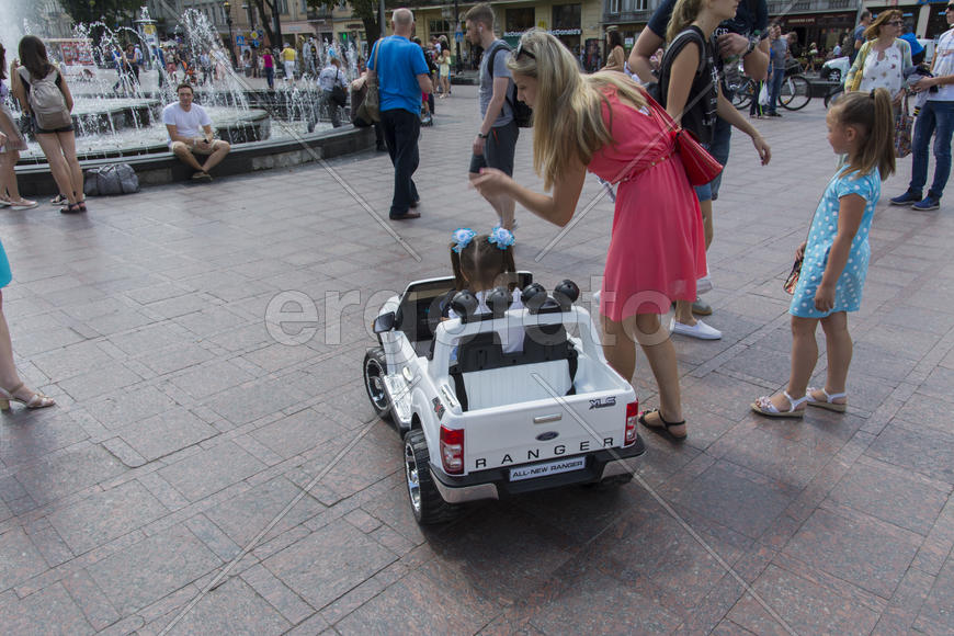A child in a baby machine in city park