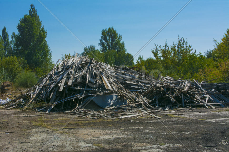 A pile of old boards in an abandoned factory in the industrial zone