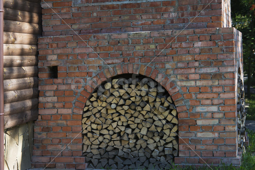 Firewood stacked near the stove near a private house