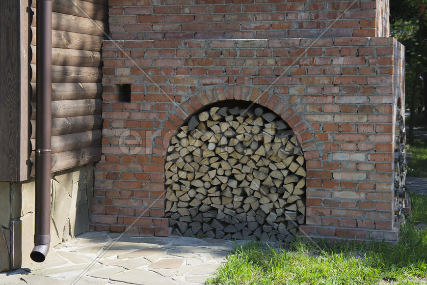 Firewood stacked near the stove near a private house