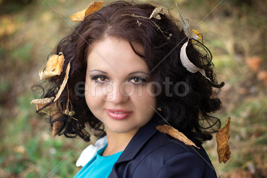 Beautiful lady with leaves in hair, autumn time