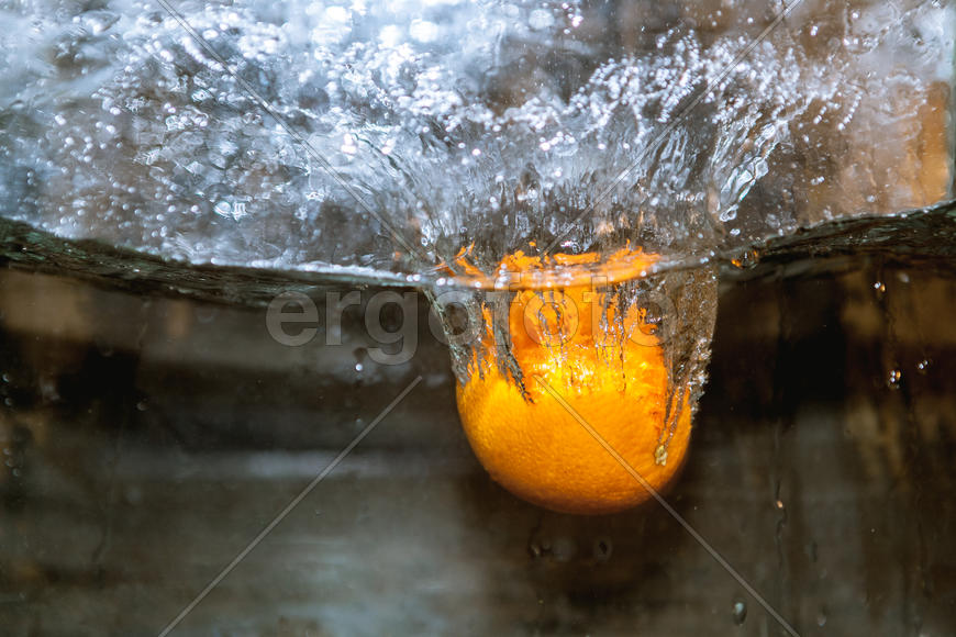 Апельсин падающий в сосуд с водой 