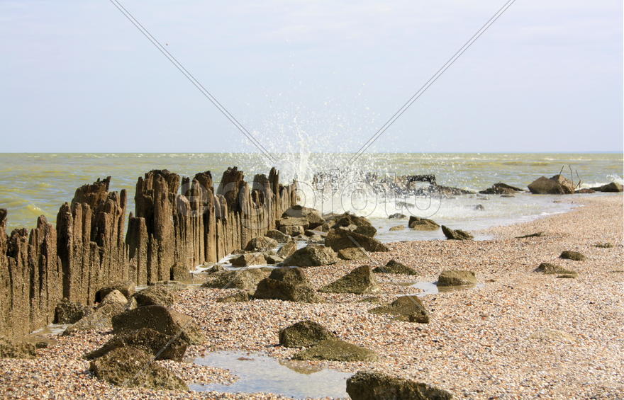 Sea waves breaking on pier on shore