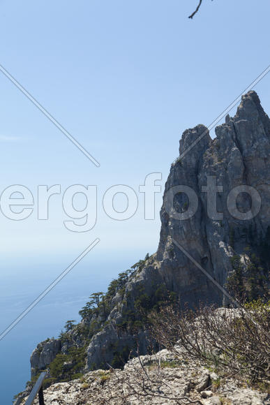 Mountains by the sea in beams of a bright sun