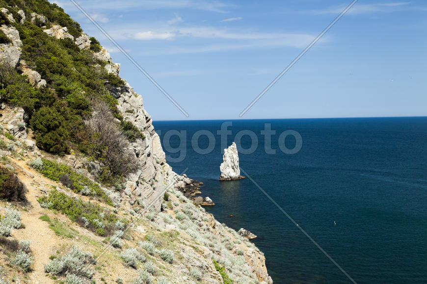 Mountains by the sea in beams of a bright sun