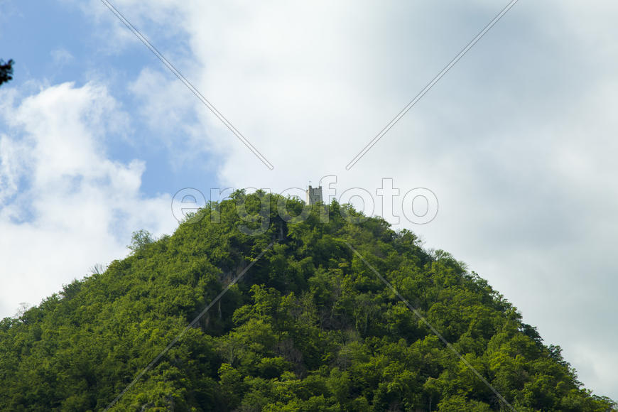 Clouds over mountains majestically float towards the sea