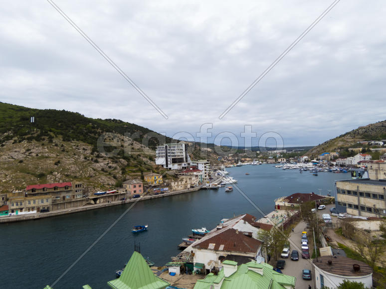 Sea bay in the city in cloudy weather