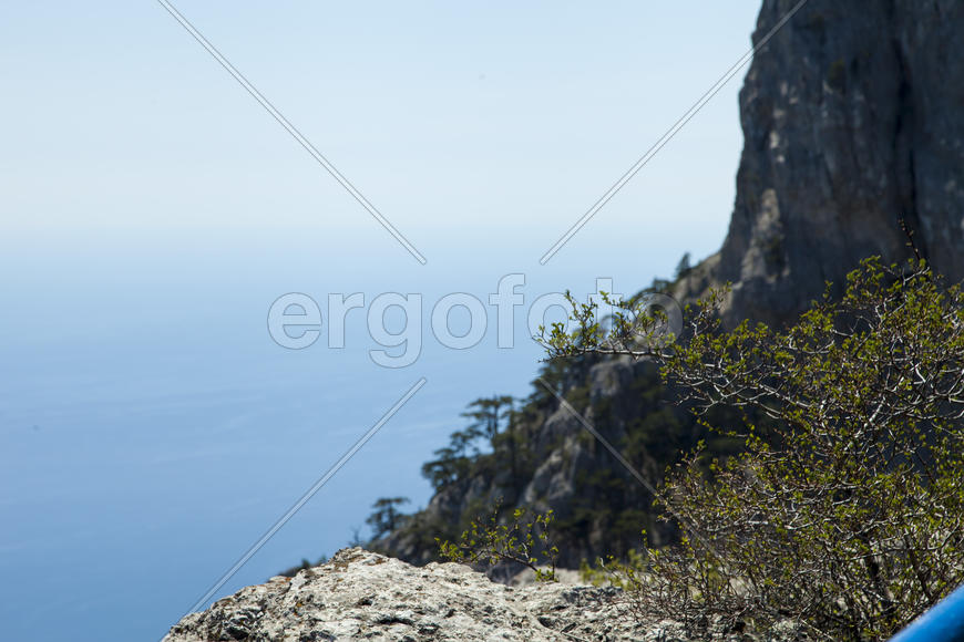 Mountains by the sea in beams of a bright sun