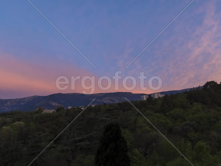 Mountains by the sea in beams of a bright sun