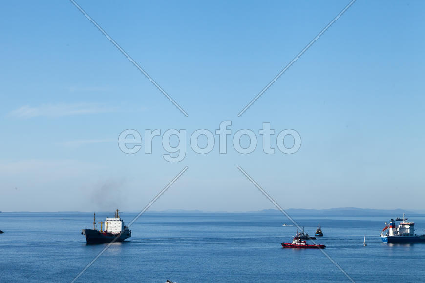 Seascape with ships and mountains on the horizon a bright sunny day