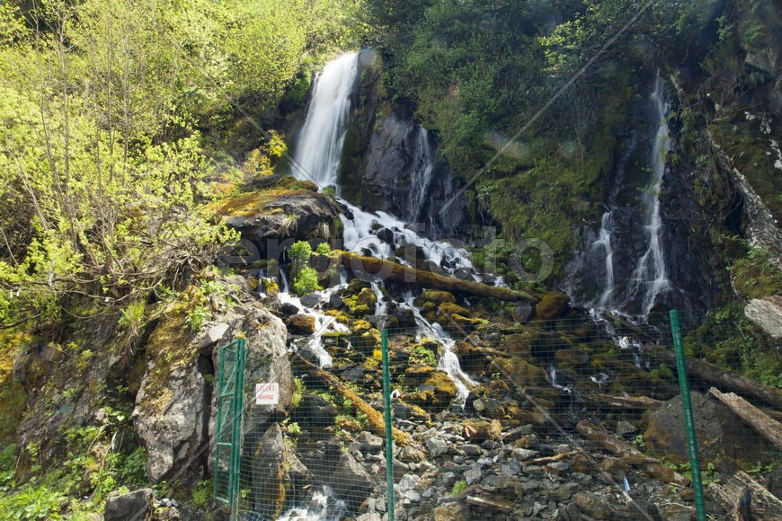The falls in mountains flow from above and rustle