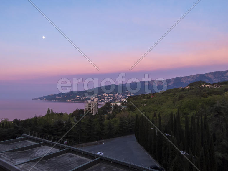 Mountains by the sea in beams of a bright sun