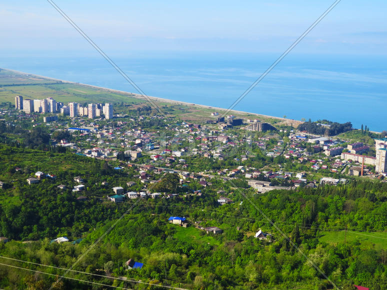 The city by the sea bathes in bright beams of the sun