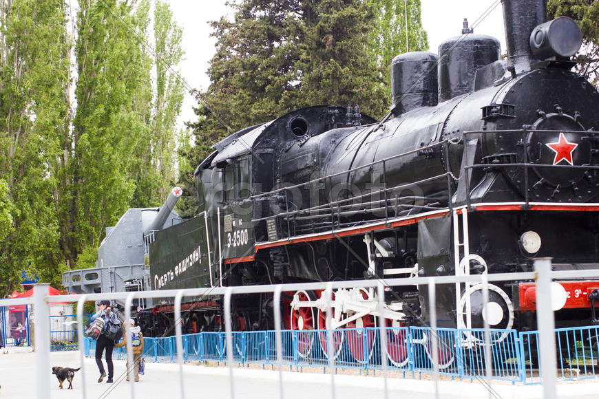 The engine as a monument costs in the middle of the city and reminds passersby of the past