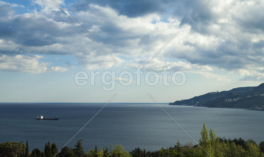 Clouds over mountains majestically float towards the sea