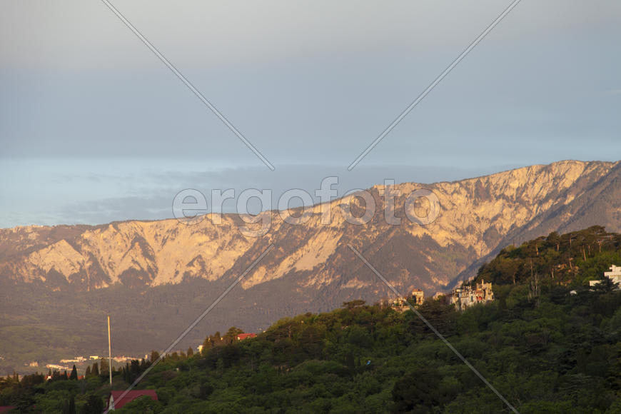 Mountains by the sea in beams of a bright sun