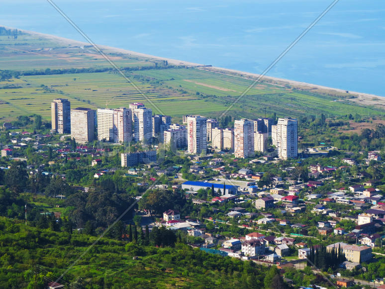 The city by the sea bathes in bright beams of the sun