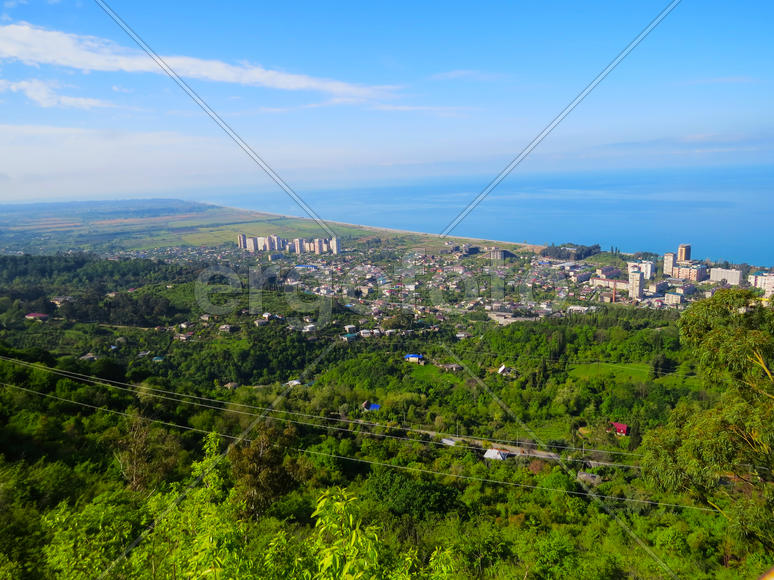 The city by the sea bathes in bright beams of the sun